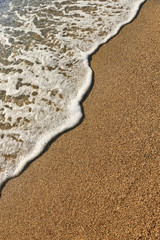 Sand on the beach and sea foam