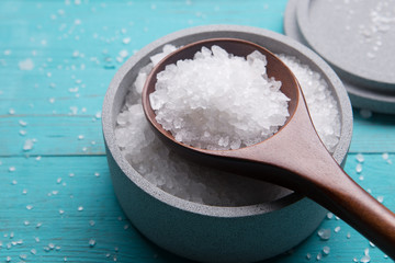 sea salt in stone bowl and wooden spoon