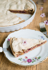 Piece of almond tart with meringue on top arranged on a plate