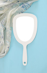 Top view image of vintage hand mirror and delicate female romantic scarf