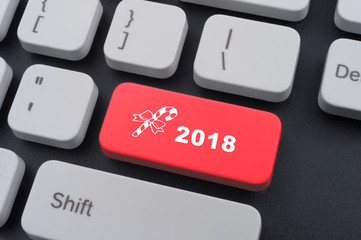 Computer notebook keyboard with 2018 key - holiday technology concept