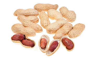 A pile of peanuts in the shell with few half opened nuts isolated on white background