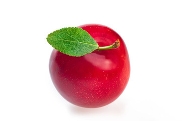Ripe tasty red plum with leaf, top view, isolated on white