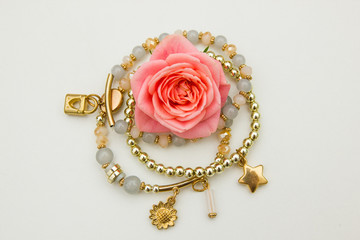 Jewelry circle with rose on the white background