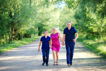 Obraz premium happy family walks in the park, run and laugh