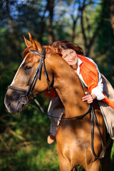 woman rides a horse in the beautiful park