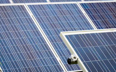 Solar energy panels. Full frame detail of a contemporary solar farm with focus on the foreground panel.