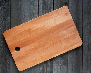 Cutting board with space for text on old wooden background. Close-up
