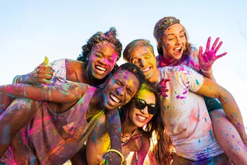 Gordijnen happy young multiethnic friends with colorful paint on clothes having fun together at holi festival © LIGHTFIELD STUDIOS