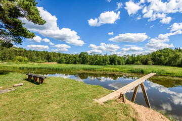 Obraz premium reflection of clouds in the lake with boardwalk