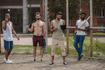 group of young multiethnic male baseball players on court