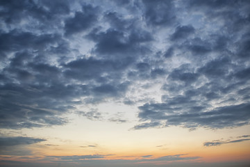Naklejka na ściany i meble Dramatic dark cloudy sky over sea, natural photo background. Dark storm clouds background