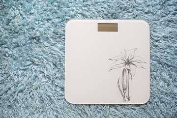 Scale / Weighing machine over fur carpet in the bathroom