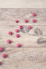 Fototapeta na wymiar Raspberries on a wooden background. Vintage tinted, filter. Copy space