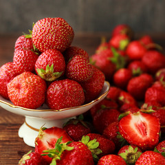 Srawberry in plate on old rustic background