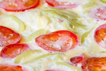 Fresh cooked vegetarian omelette from eggs, tomatos and bell pepper. Selective focus, closeup