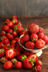 Srawberry in plate on old rustic background