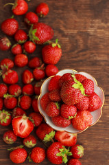 Srawberry in plate on old rustic background