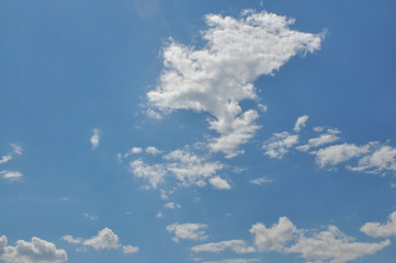 Background with a blue sky and white clouds. White fluffy clouds in the blue sky
