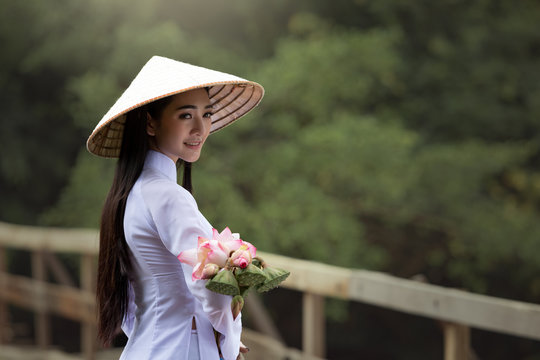Medium long shot beautiful woman wearing Ao Dai Vietnam traditional dress