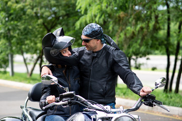 Fototapeta na wymiar A beautiful couple in love is riding a motorbike.