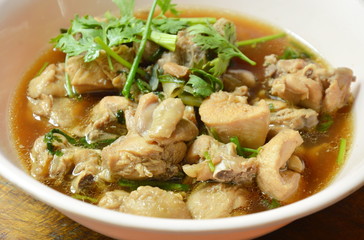 boiled chop chicken fish sauce soup topping parsley and spring onion on bowl