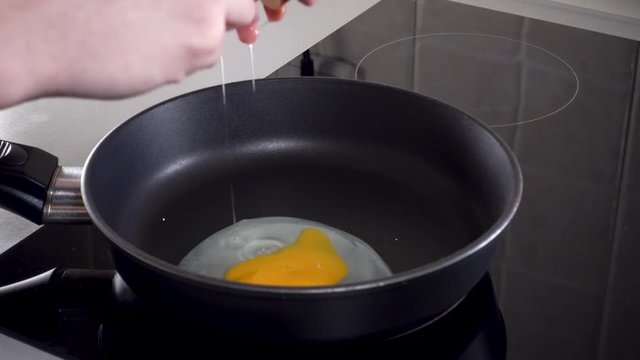 Cooking eggs in a hot frying pan.