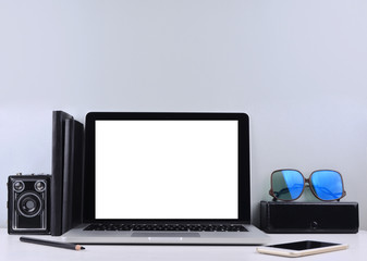 Stylish workspace with laptop computer, office supplies.