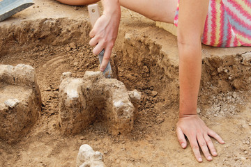 Archeological tools, Archeologist working on site, hand and tool.
