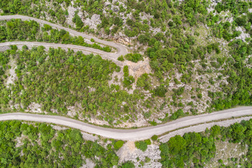 Top view of a winding car road in the mountains