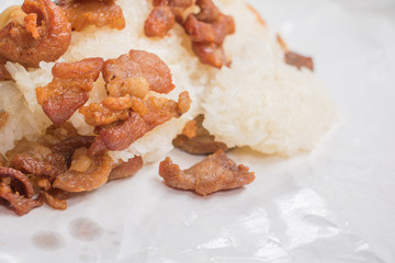 pork fried Close up with sticky rice on wrap paper fast food Thailand