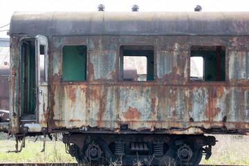 Fototapeta na wymiar Old rusty carriage standing in the abandoned depot