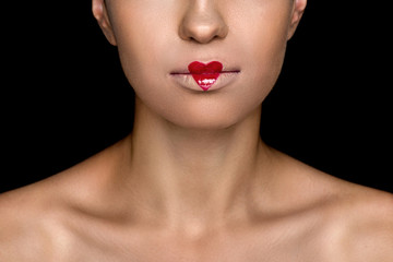 cropped view of seductive fashionable woman with heart on lips, isolated on black