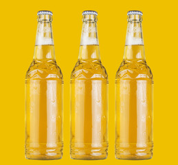 Three bottles of beer on the yellow background.