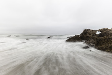 Rocky Leo Carrillo State Beach with motion blur water in Malibu, California.