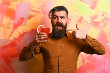 Brutal caucasian hipster holding tropical alcoholic fresh cocktail