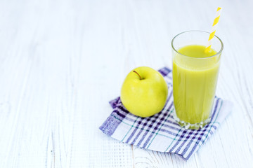 A glass of apple juice and apples. Top view. Copy space. The concept is healthy food, vegan, diet, weight loss.