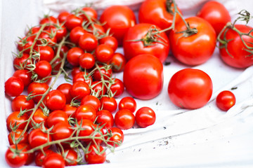 Ripe red cherry tomatoes in a basket  on a market stall close up image