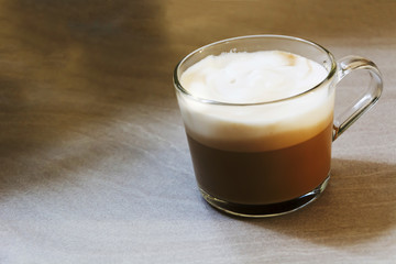 Glass mug with foamy cappuccino