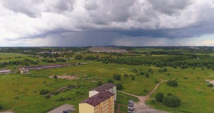 Aerial view of dramatic storm clouds over city, heavy rainfall is coming. Aerial footage. Point of interest, orbit flight.