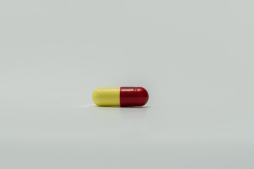 Red, Yellow capsule pills isolated on white background