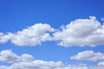 Fototapeta na wymiar Beautiful big white clouds over blue sky, sunny summer day, close up