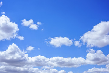 Naklejka na ściany i meble Beautiful big white clouds over blue sky, sunny summer day, close up