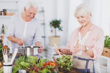 Senior man and woman preparing food