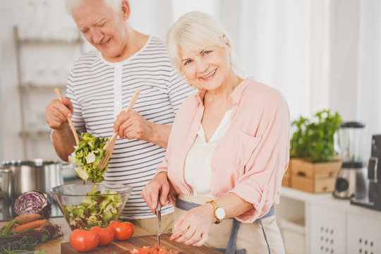 Senior man and woman preparing food
