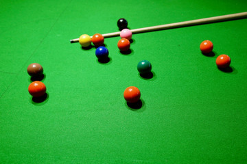 snooker balls and cue on snooker table