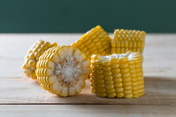 Fresh corn sliced on wooden table