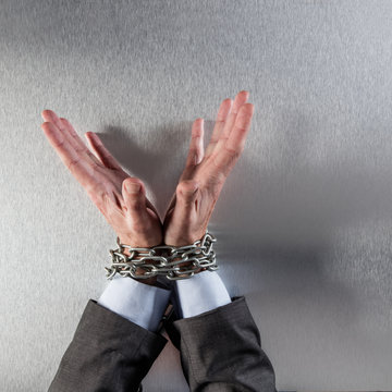 innocent professional man hands tied with chain for suspicious management