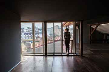 girl watcing on the mansarde window