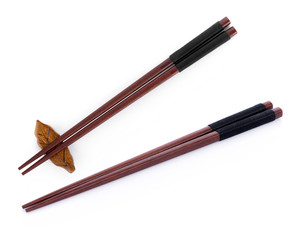 Wooden pairs of chopsticks on white background